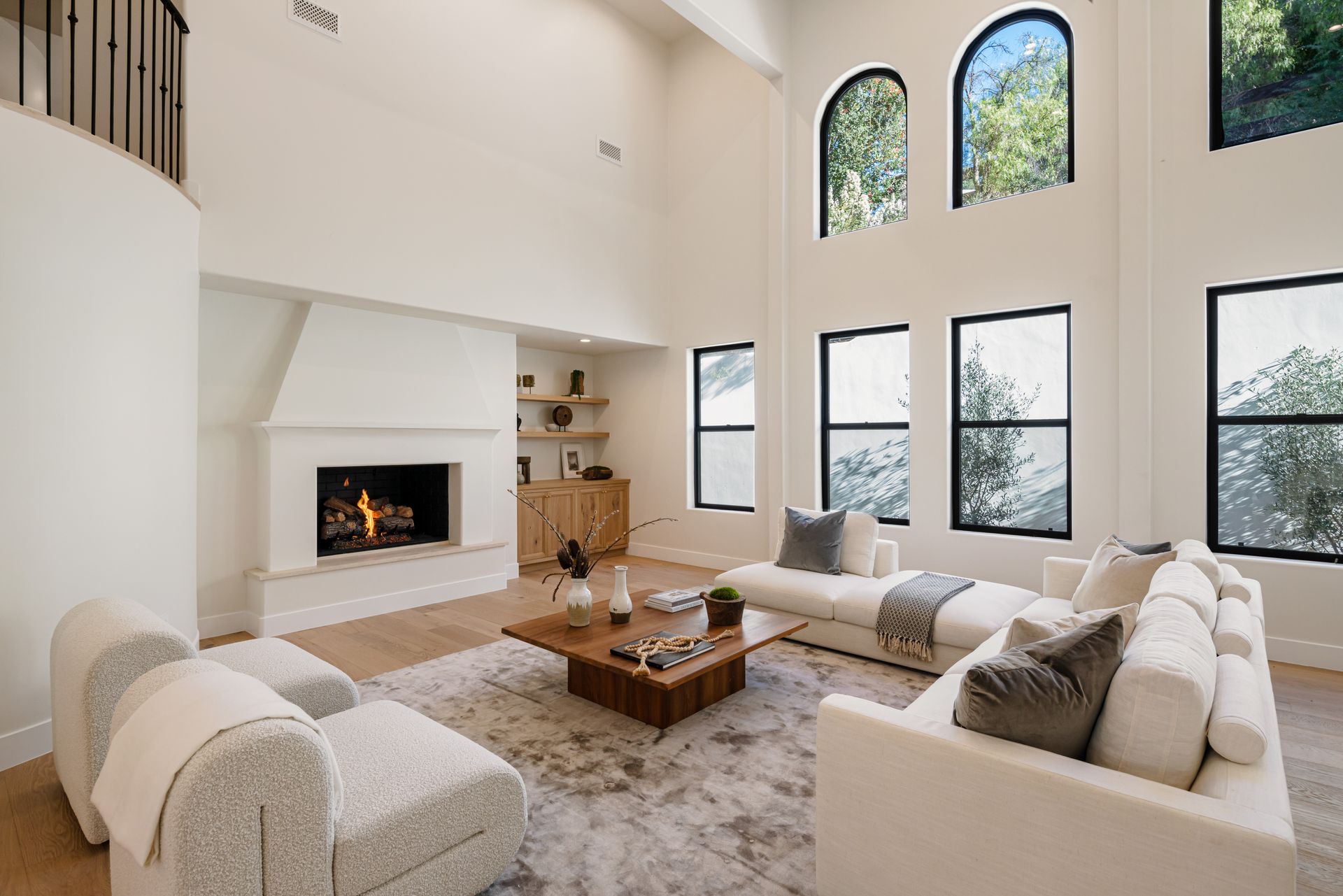 A living room with a couch , chair , coffee table and fireplace.
