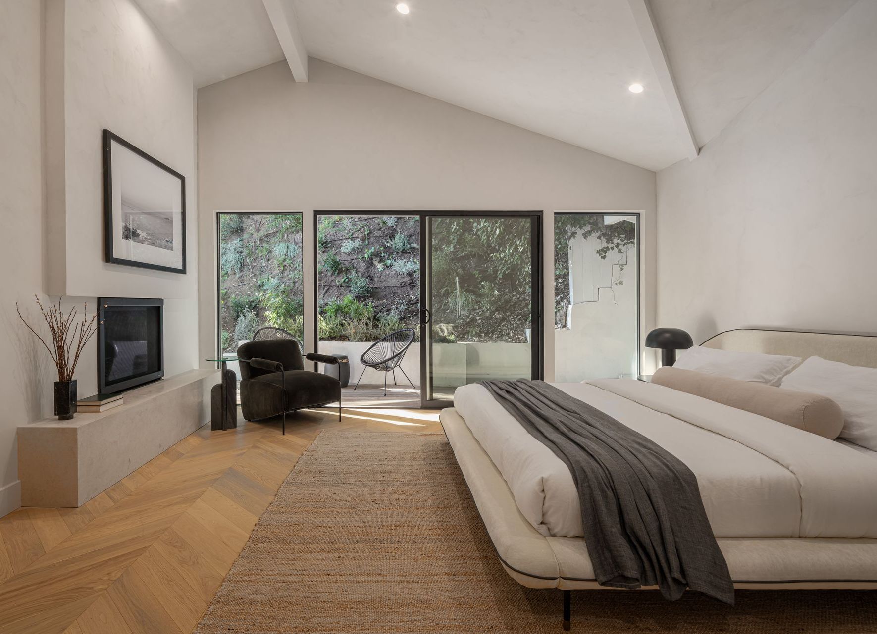 A chair and ottoman are in a living room next to a window.