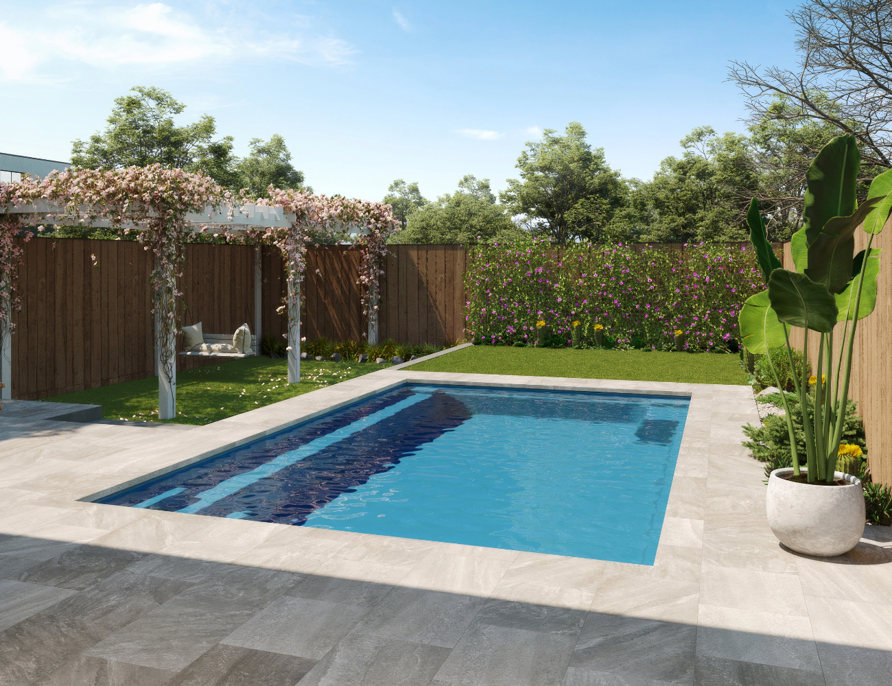 Backyard with rectangular pool, patio, wooden fence, lush greenery, and pergola.