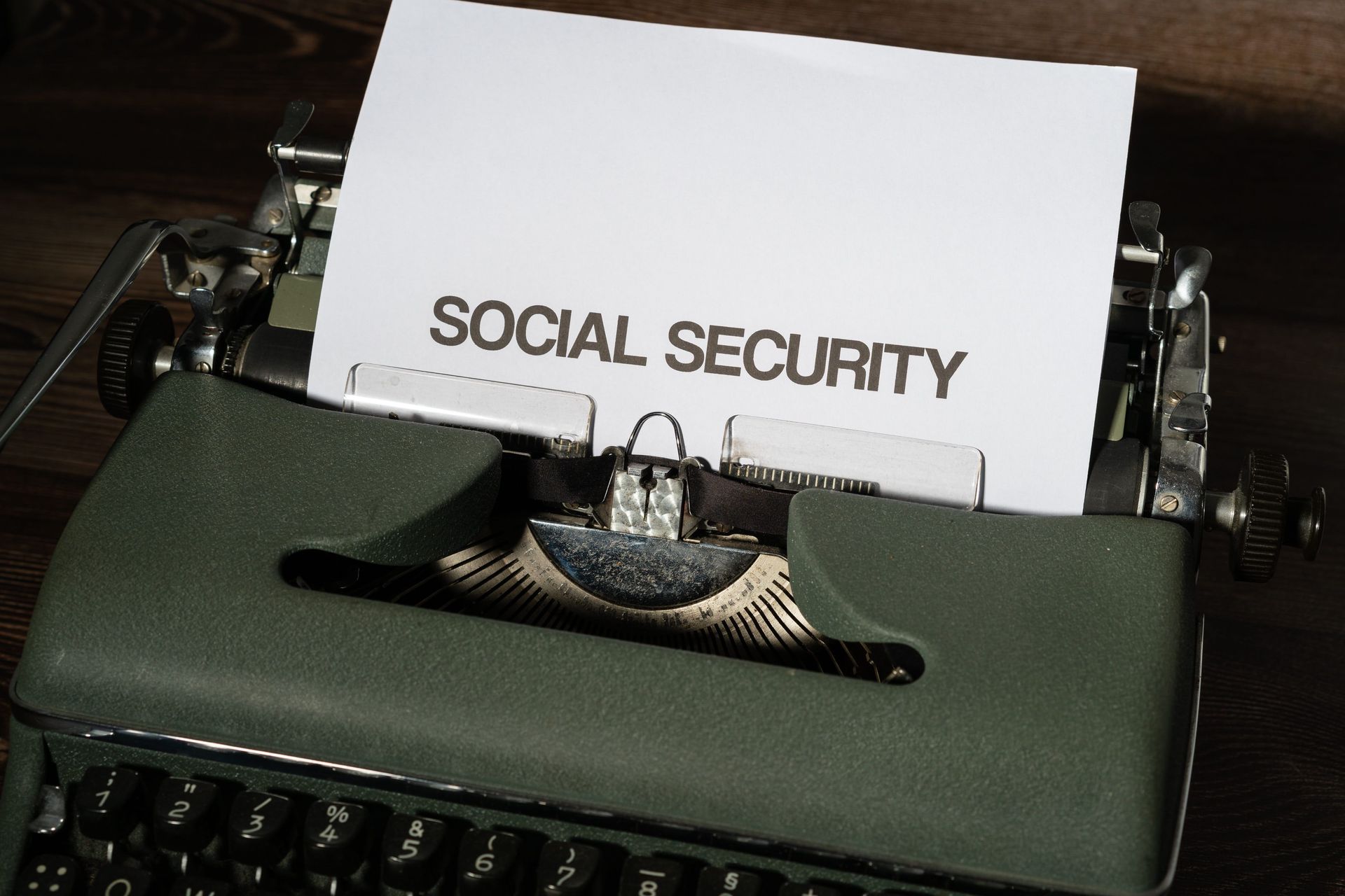 A typewriter with paper reading “SOCIAL SECURITY” inserted in the carriage.