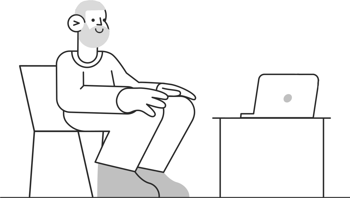 Um homem está sentado em uma cadeira em frente a um laptop.