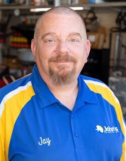 Man with beard wearing a blue and yellow shirt, with