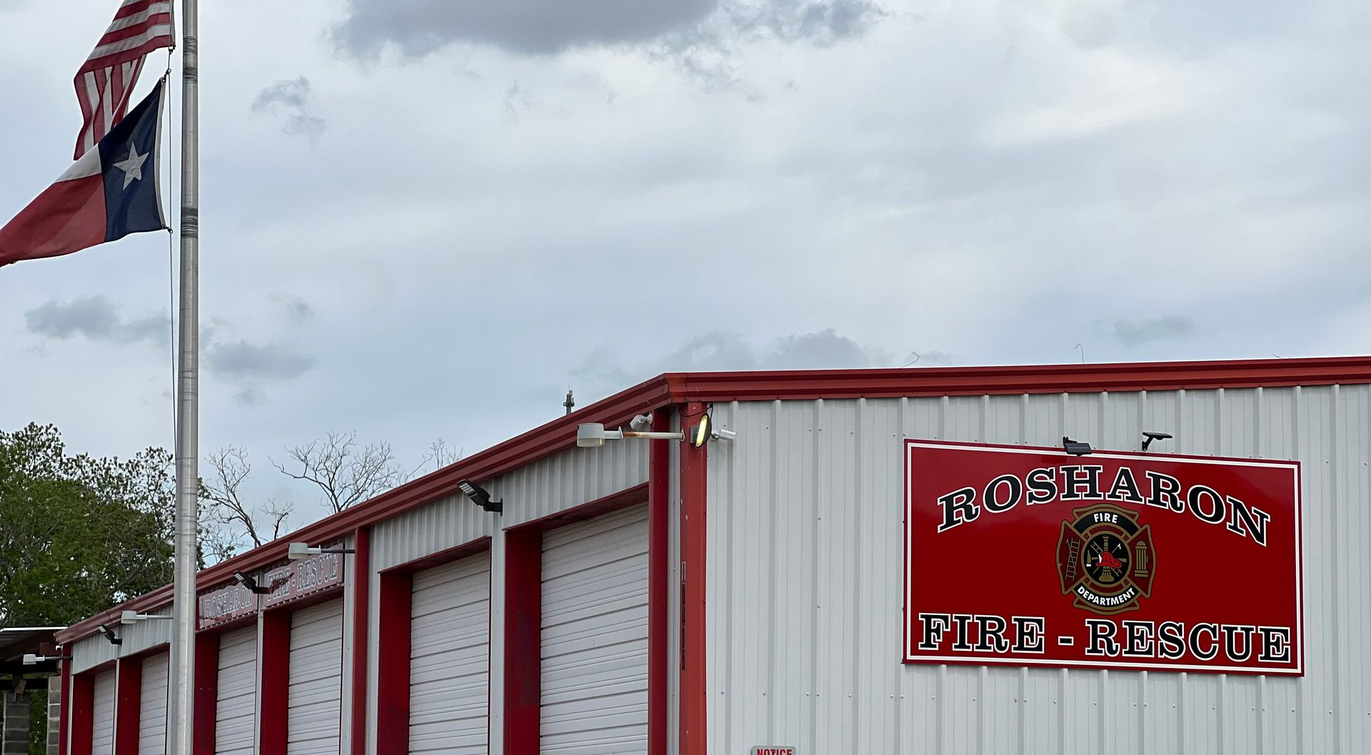 Red-and-white fire rescue station with an American flag in Rosharon.