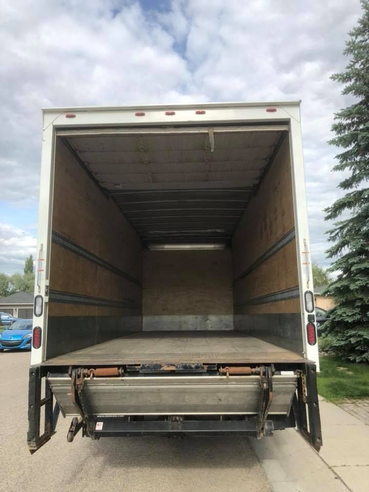 The back of an empty moving truck with the door open