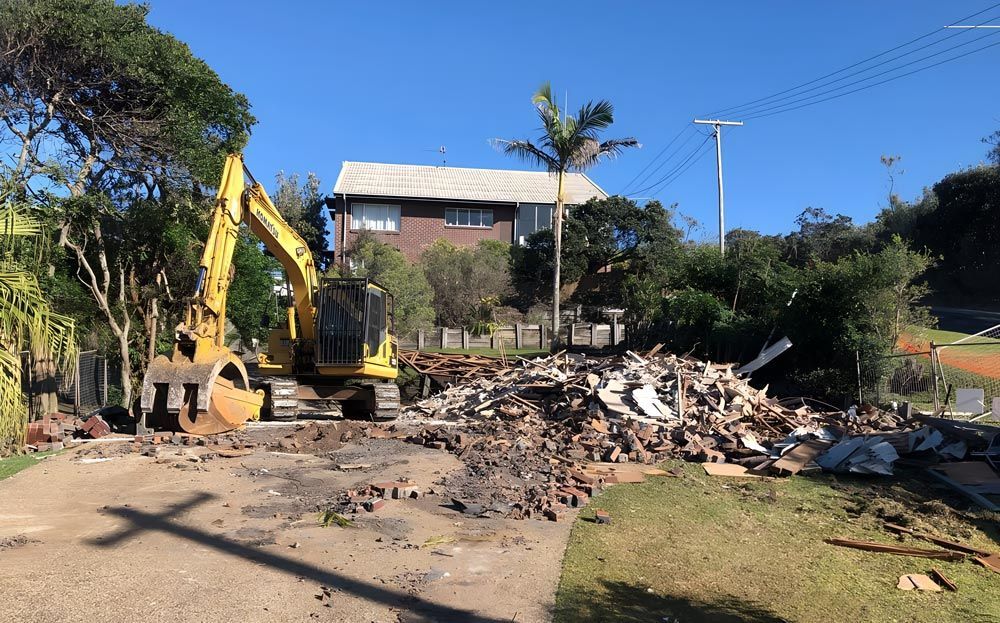 Digger Actively Demolishing A House 