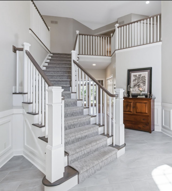 A staircase in a house with a wooden railing