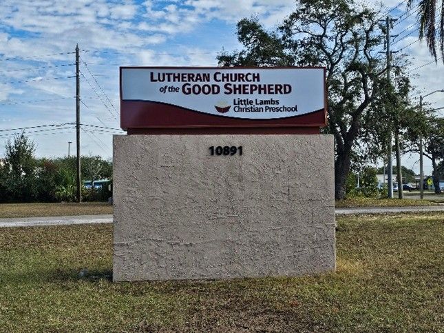 Custom outdoor school sign displayed on a brick base near a church and preschool entrance. Custom outdoor school sign displayed on a brick base near a church and preschool entrance.