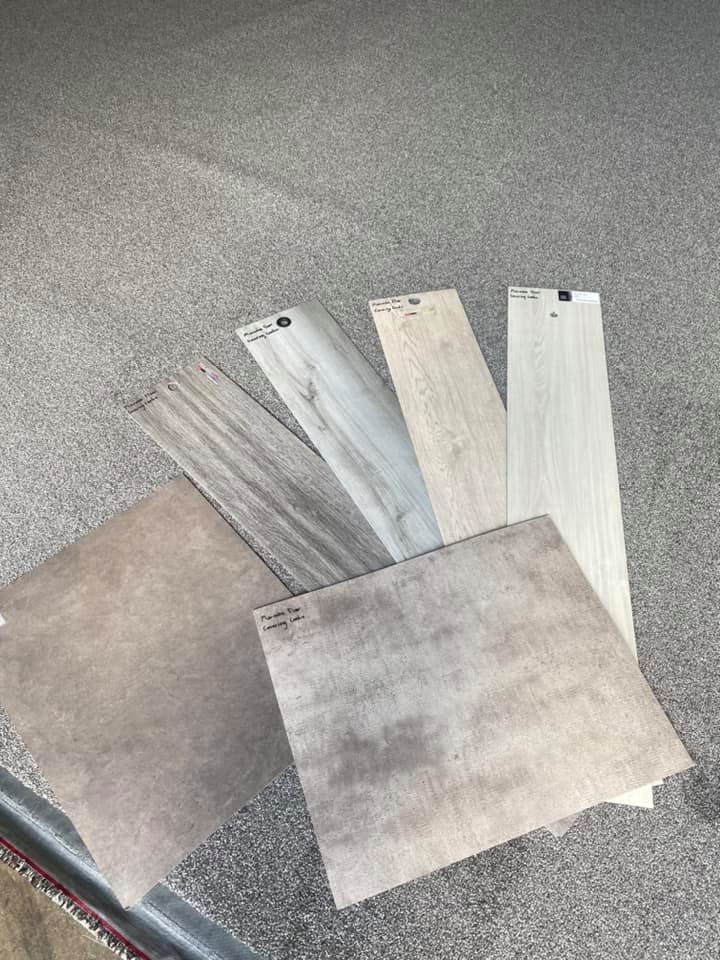 Tiles Samples In Neutral Colors Arranged On A Carpeted Surface — Mareeba Floor Covering Centre in Mareeba, QLD