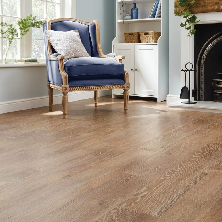 Wooden Floor In A Living Room With A Blue Armchair — Mareeba Floor Covering Centre in Tablelands, QLD