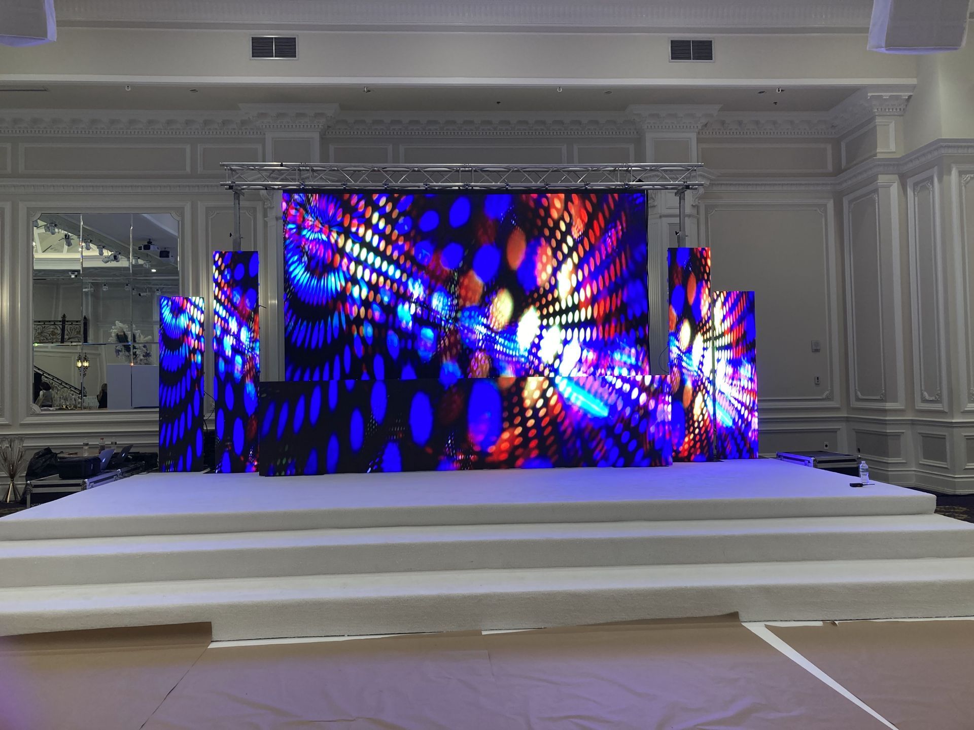 LED Video Wall and A large stage with a lot of lights on it in a room.