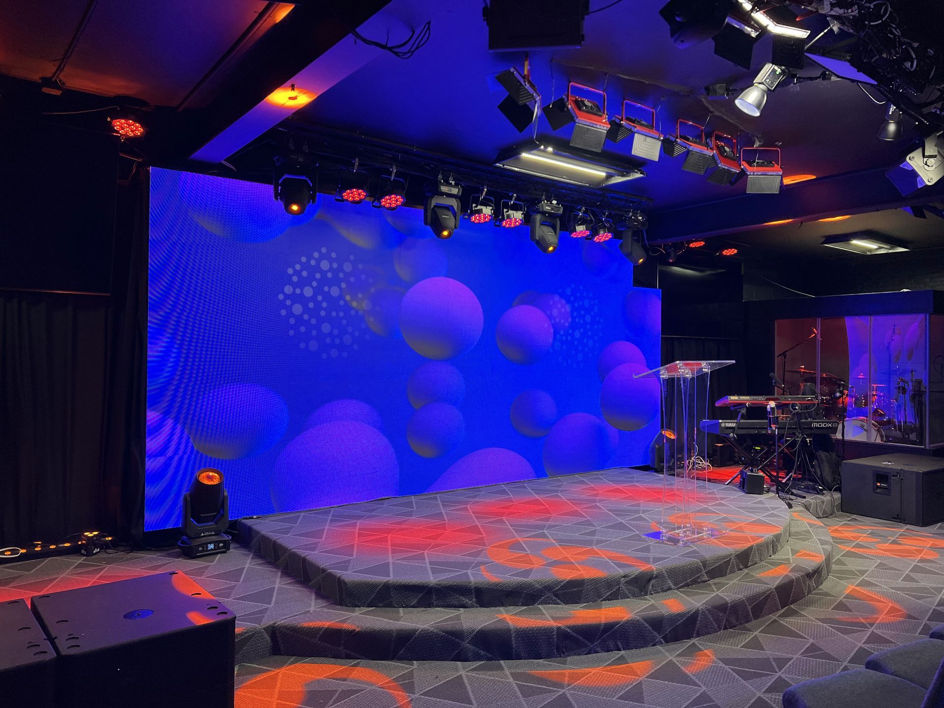 LED Video Wall and A stage with a large screen and a lot of lights on it.