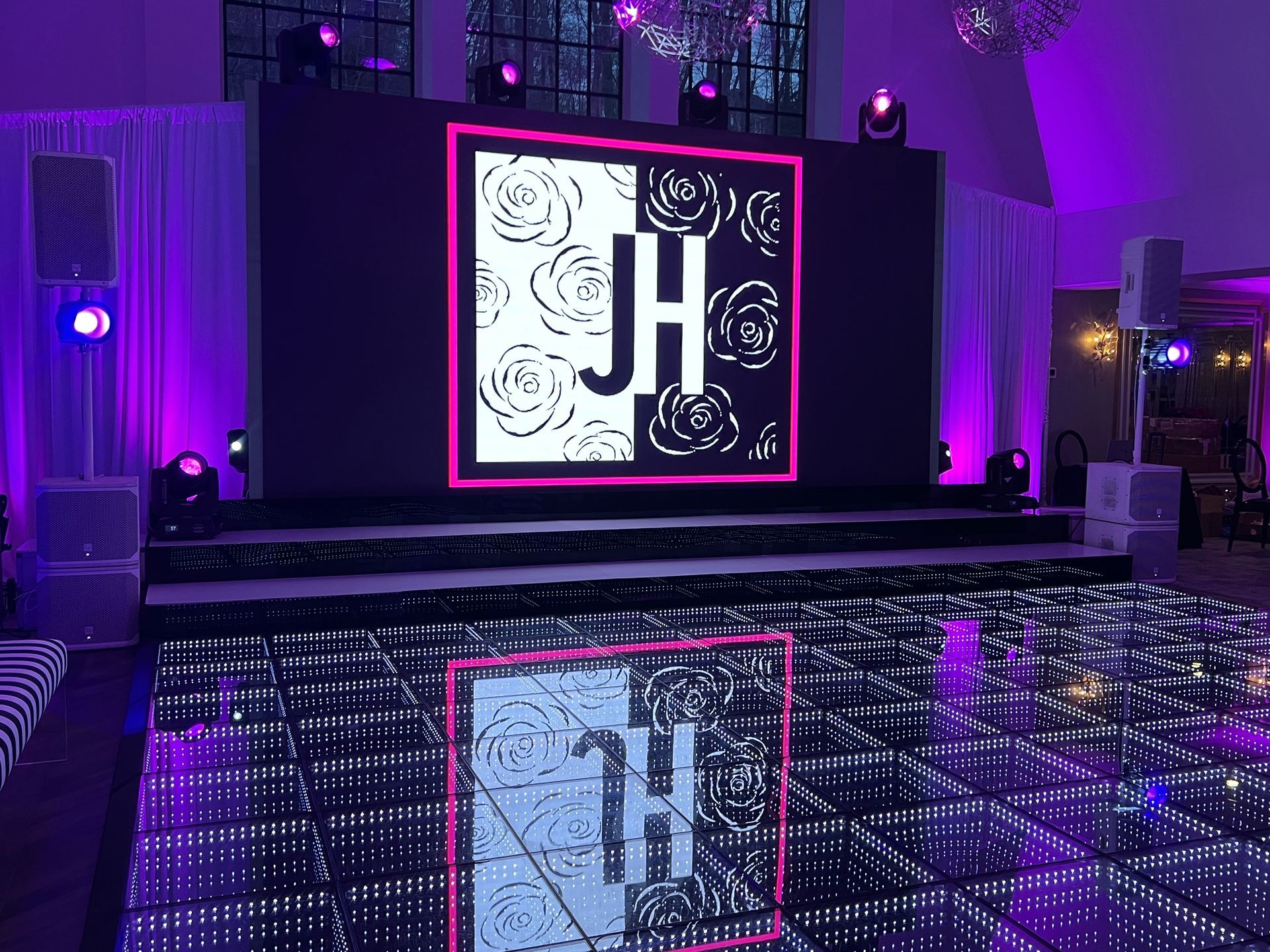 LED Video Wall and A large screen with the letters jh on it is sitting on top of a dance floor.