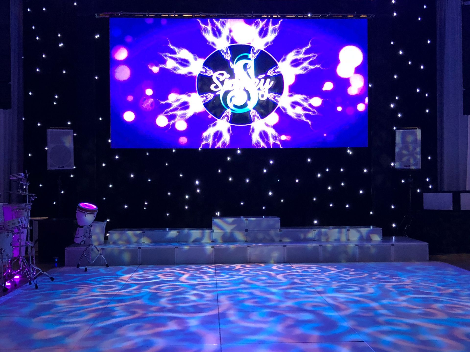 LED Video Wall and A stage with a large screen and a dance floor