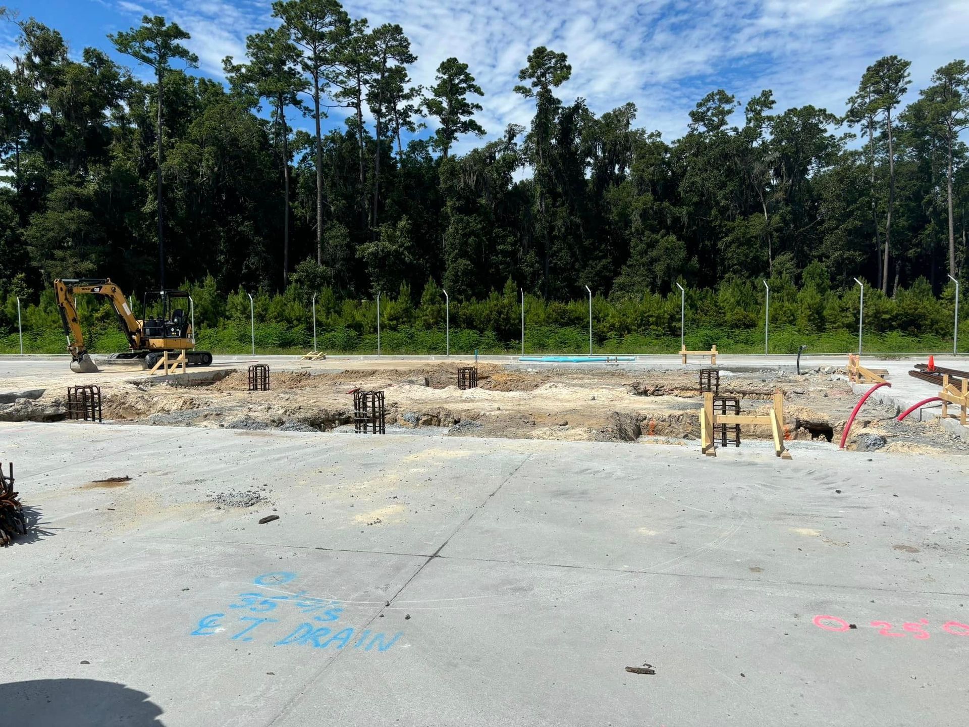 A construction site with a lot of trees in the background