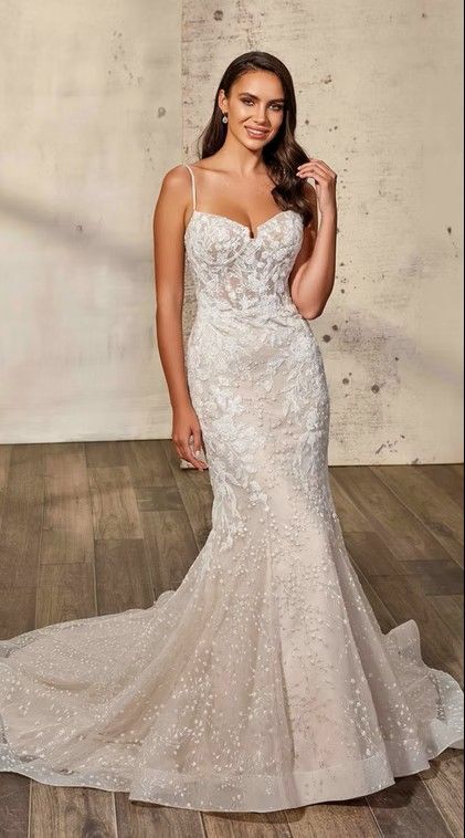 Woman in a sparkling strapless silver mermaid gown posing indoors with a long train. Orla - DR2541