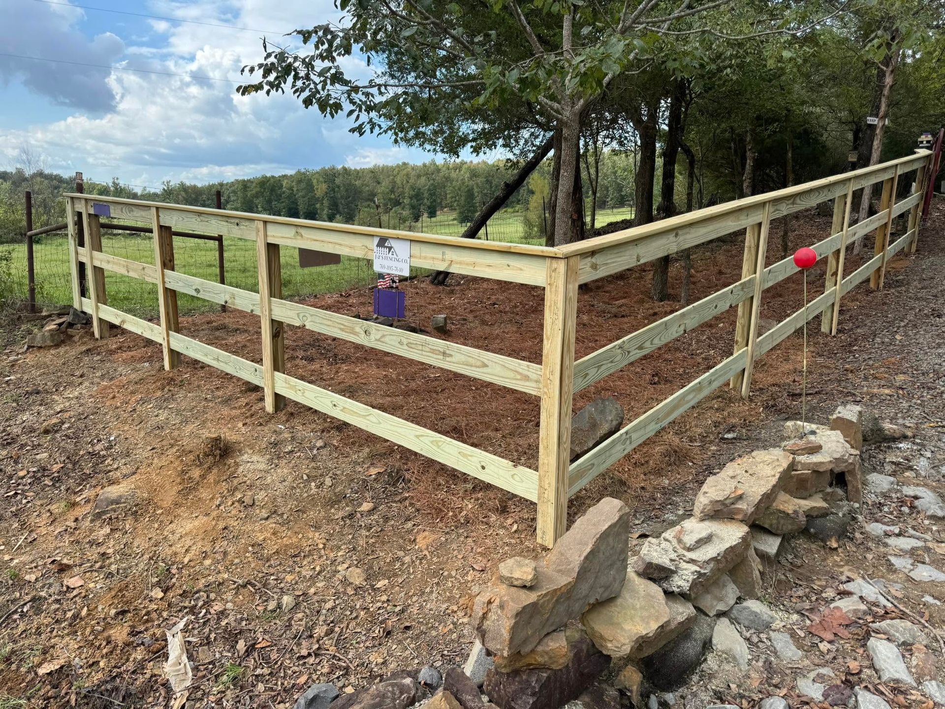 Wooden fenced enclosure installation by J&S Fence Company photo