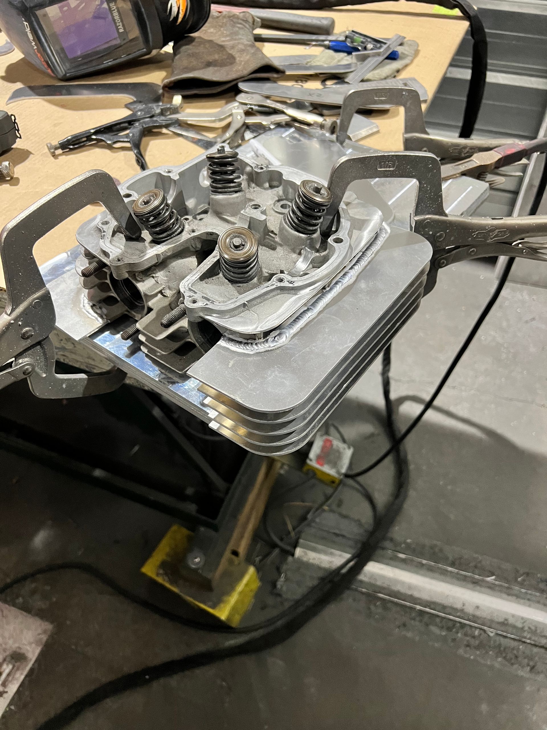 Cylinder head clamped for weld repair at TDS Fabrication