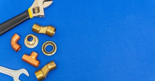 Tools and plumbing parts on a blue surface, with ALPRO logo in the top right corner. Tools and plumbing parts on a blue surface, with ALPRO logo in the top right corner.