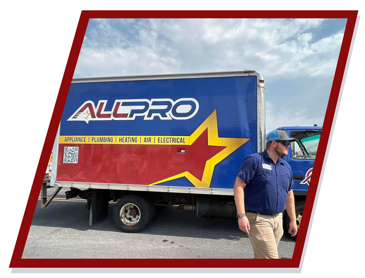 Man in blue shirt near Allpro moving truck, blue and red with a star logo. Man in blue shirt near Allpro moving truck, blue and red with a star logo.