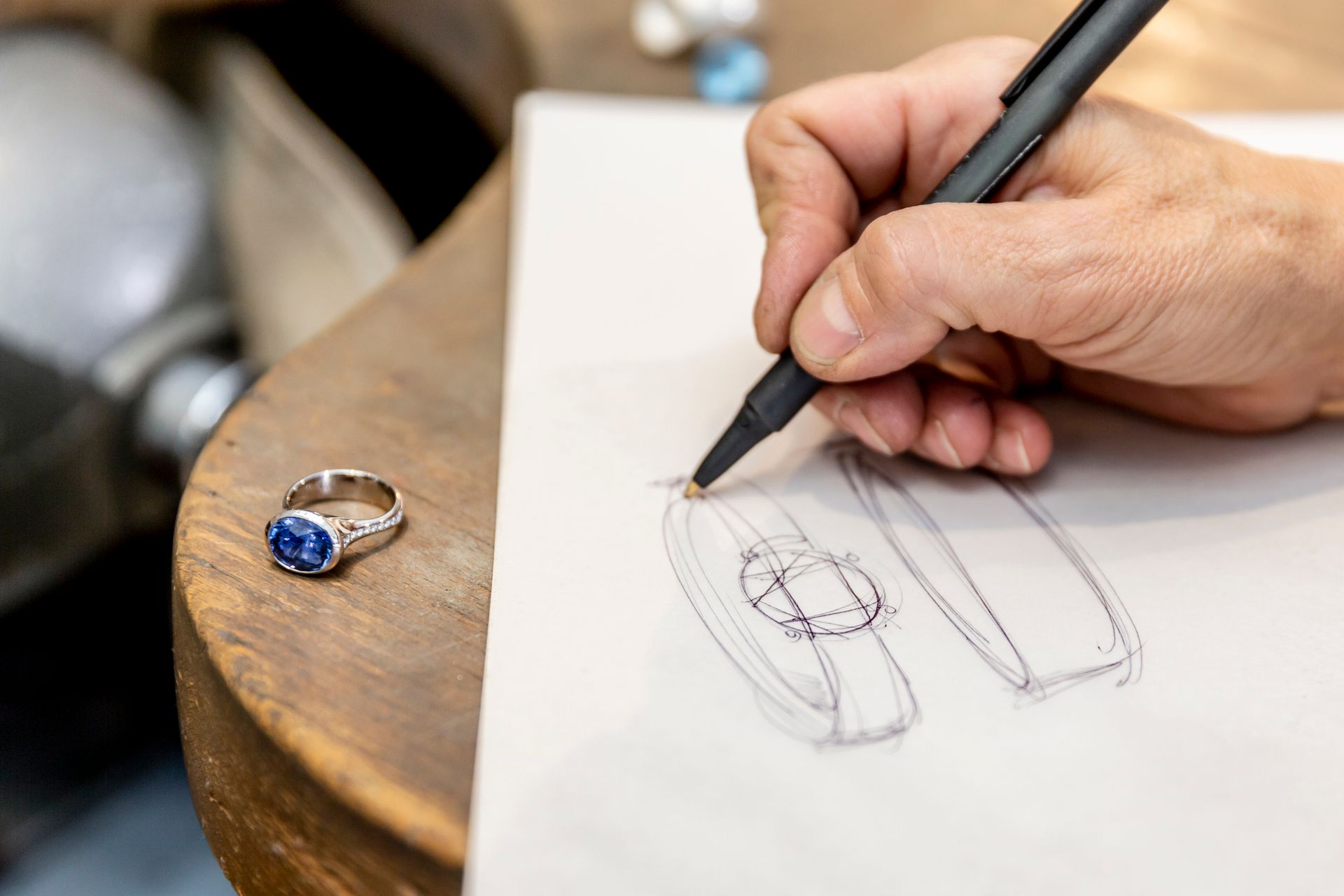 Jewelry designer at Diamonds & Designs working on creative jewelry design in Dallas, TX and sketches
