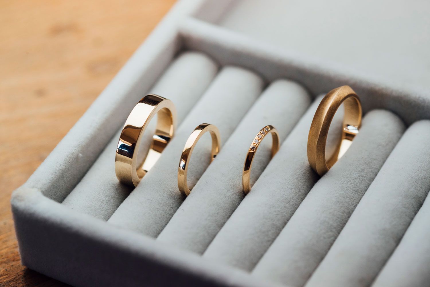 A collection of handcrafted golden rings on display in a jewelry store.