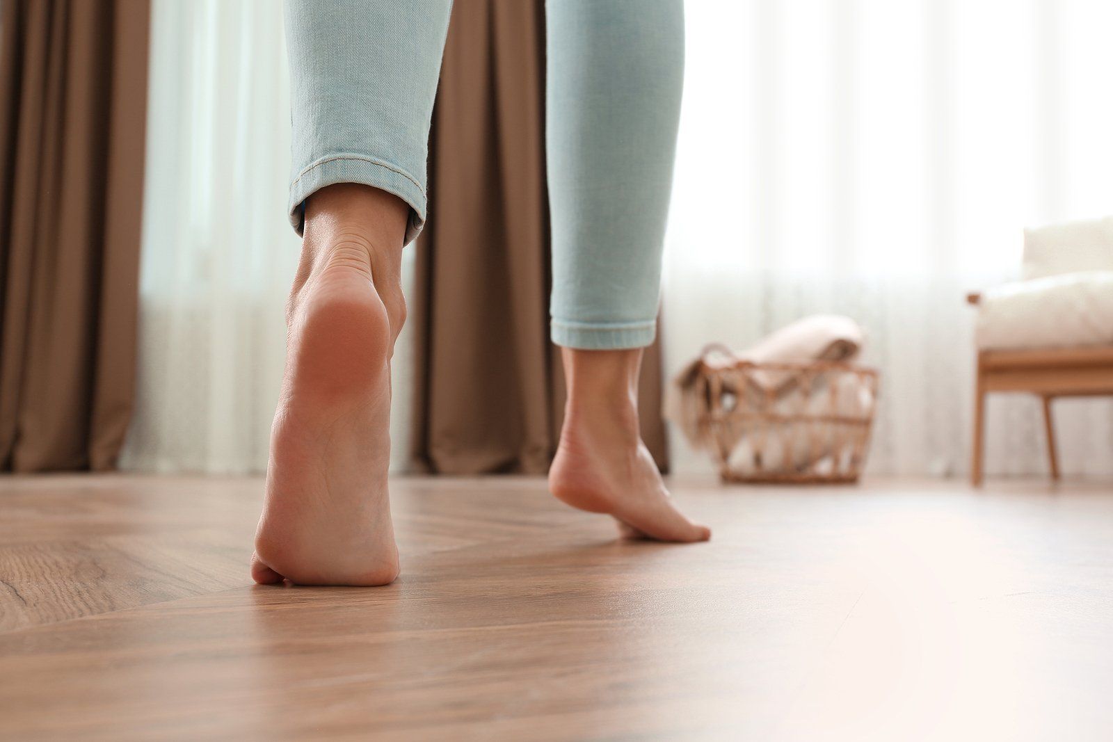 Hydronic Heating Repair Services Near You Bare feet walking on a wooden floor in a bright room