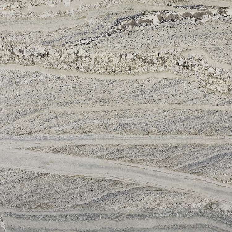 A close-up view of a light-colored, layered rock formation.
