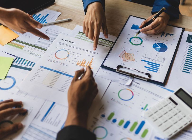 Workers reviewing the business report