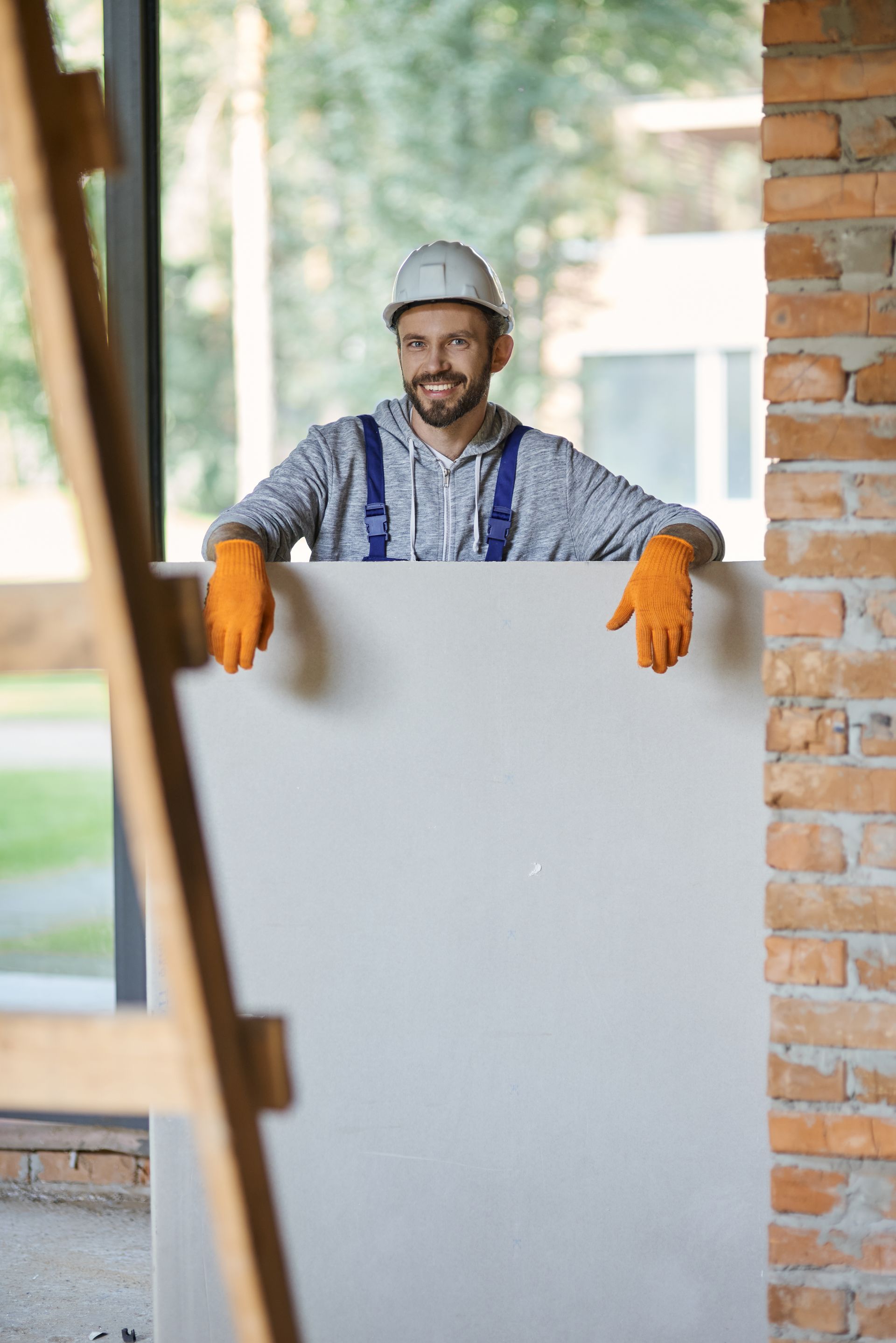young male builder in hard hat smiling