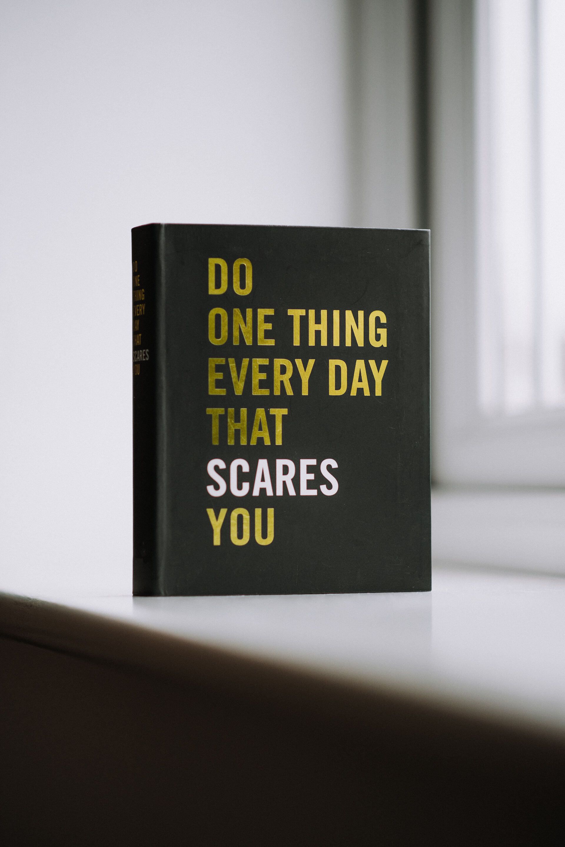Black book with gold and white text: 