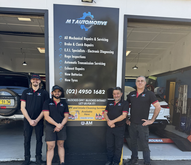 Mechanic Working in a Cluttered Auto Repair Shop With Tools — M T Automotive In Wallsend, NSW