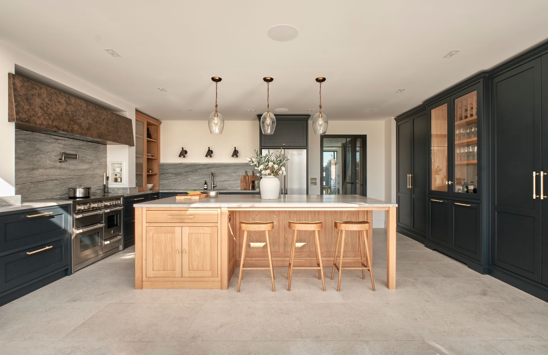 a kitchen with two wooden stools and a tray on the counter