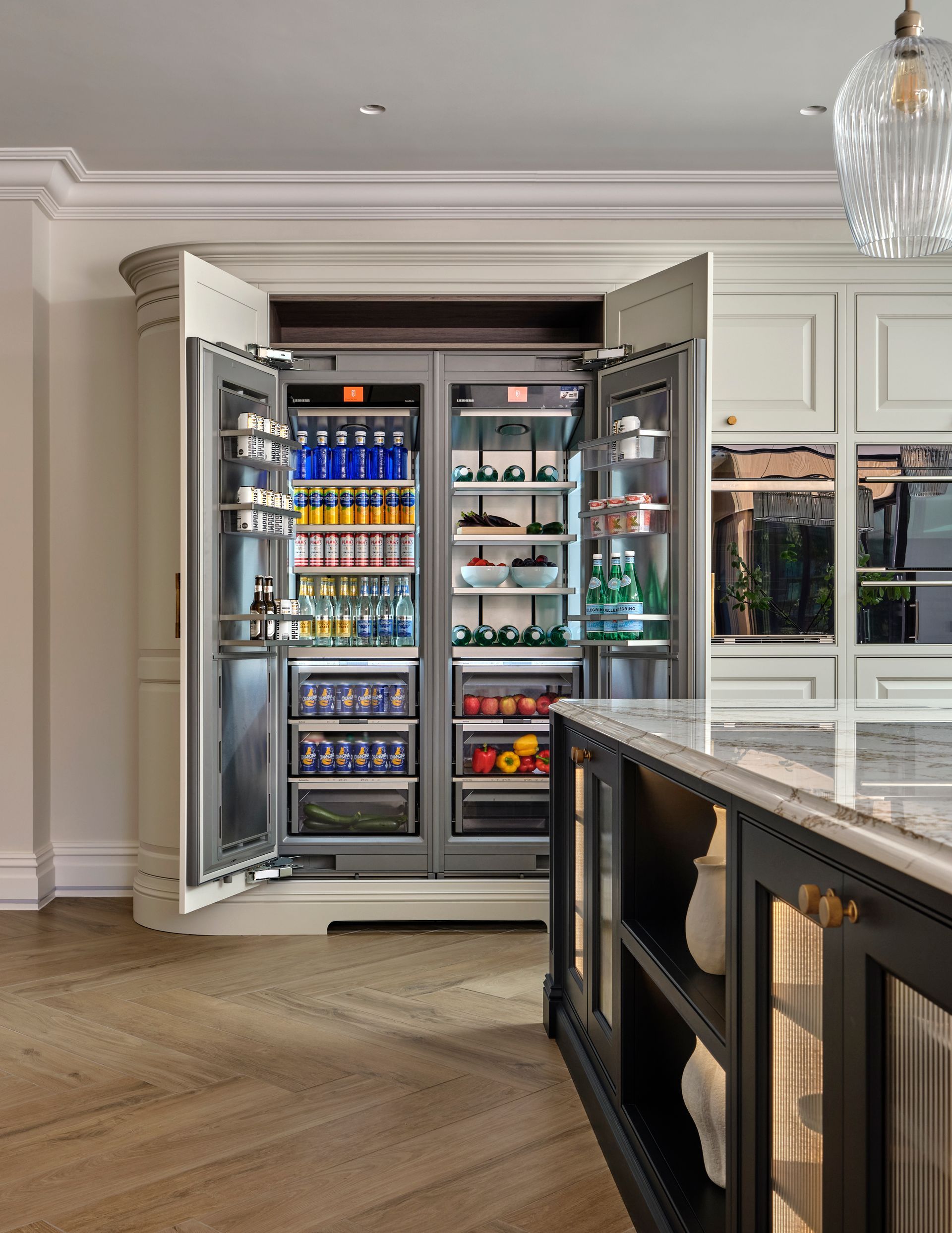 a kitchen with a stainless steel refrigerator and a pantry