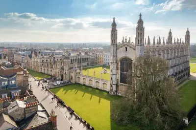 an aerial view of a large building with a clock tower an aerial view of Great St Mary's Church (Church of England), Cambridge