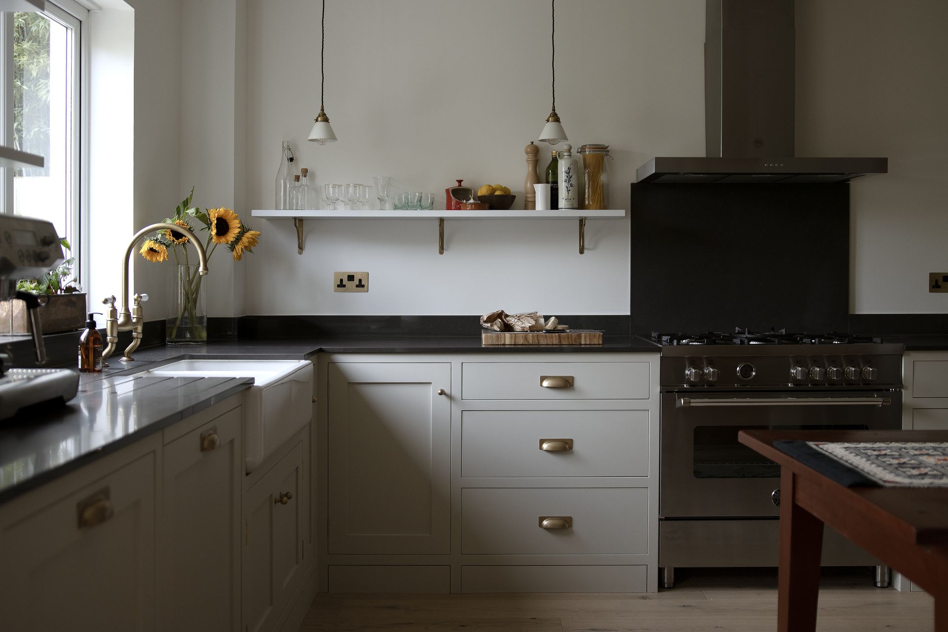 a handmade kitchen with stainless steel appliances and white cabinets