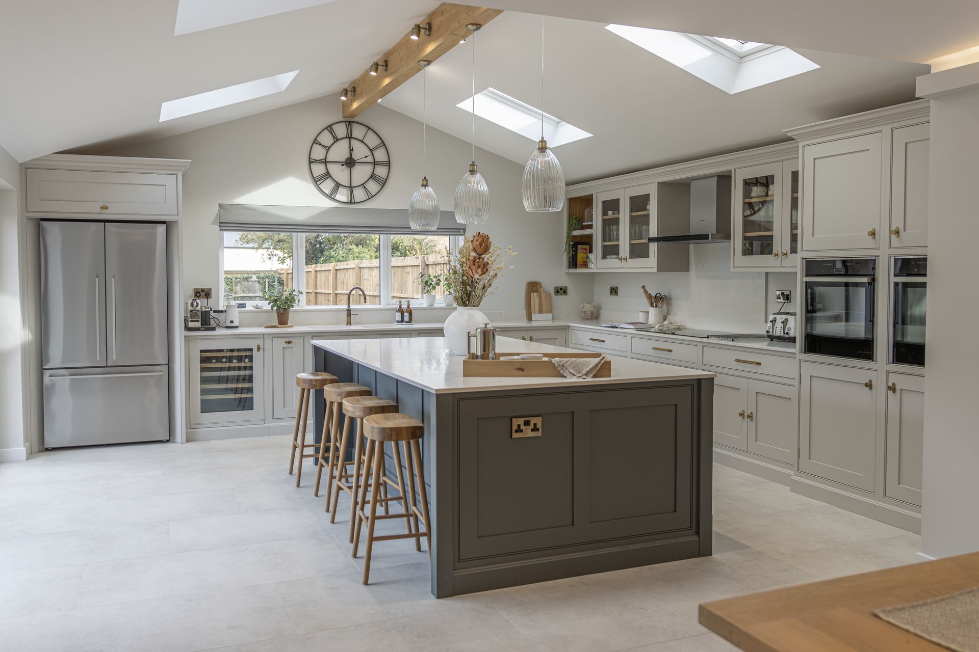 a kitchen with a large island and a clock on the wall