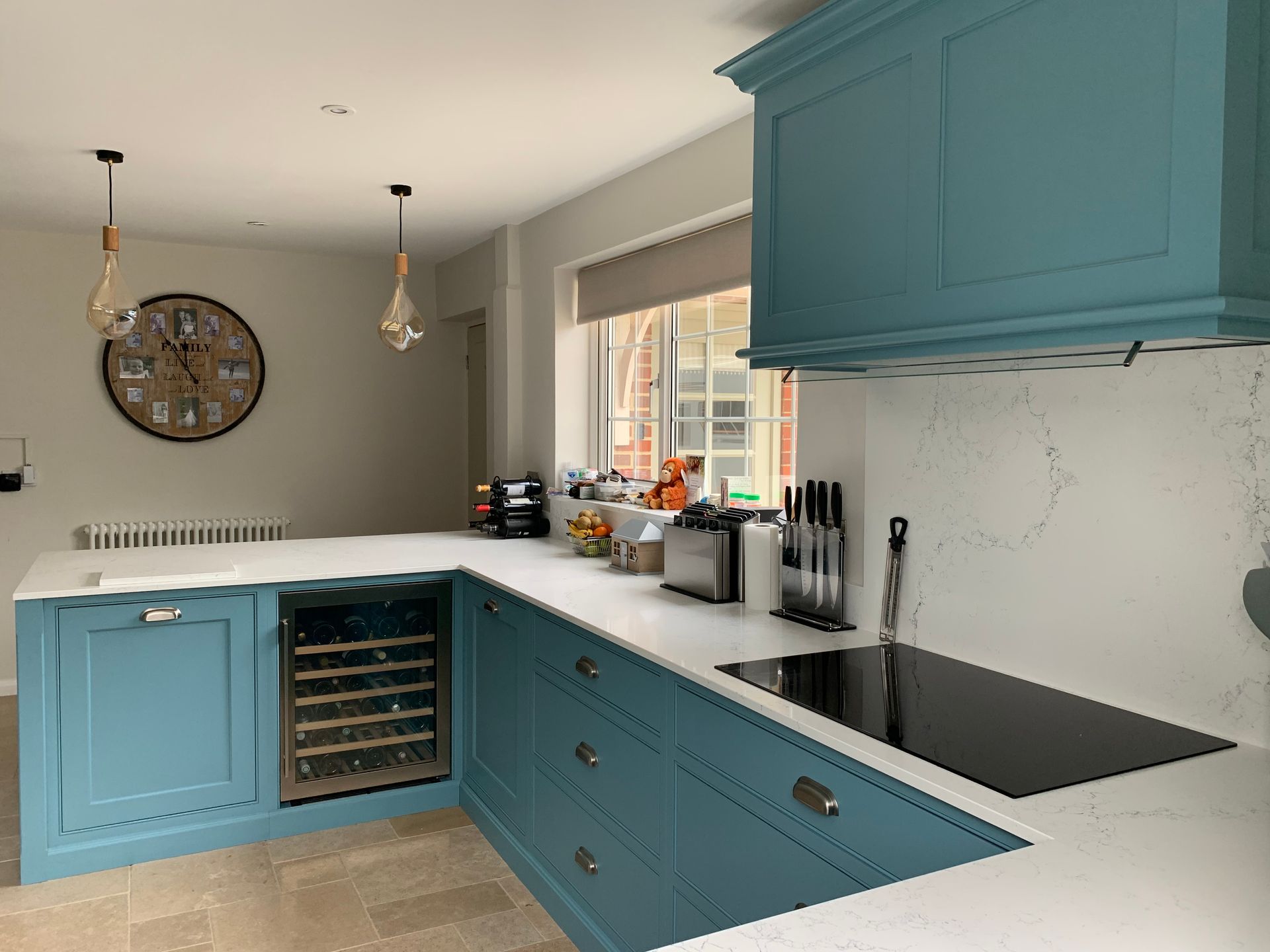 a luxury kitchen with blue cabinets and white counter tops