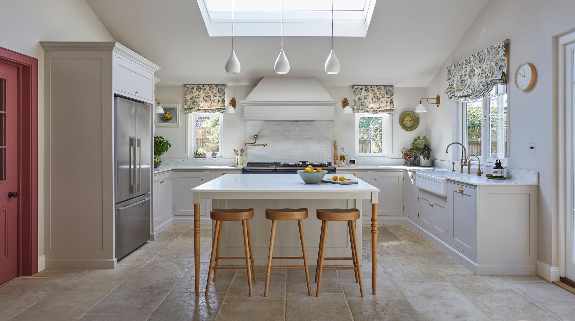 a kitchen with white cabinets and wooden stools