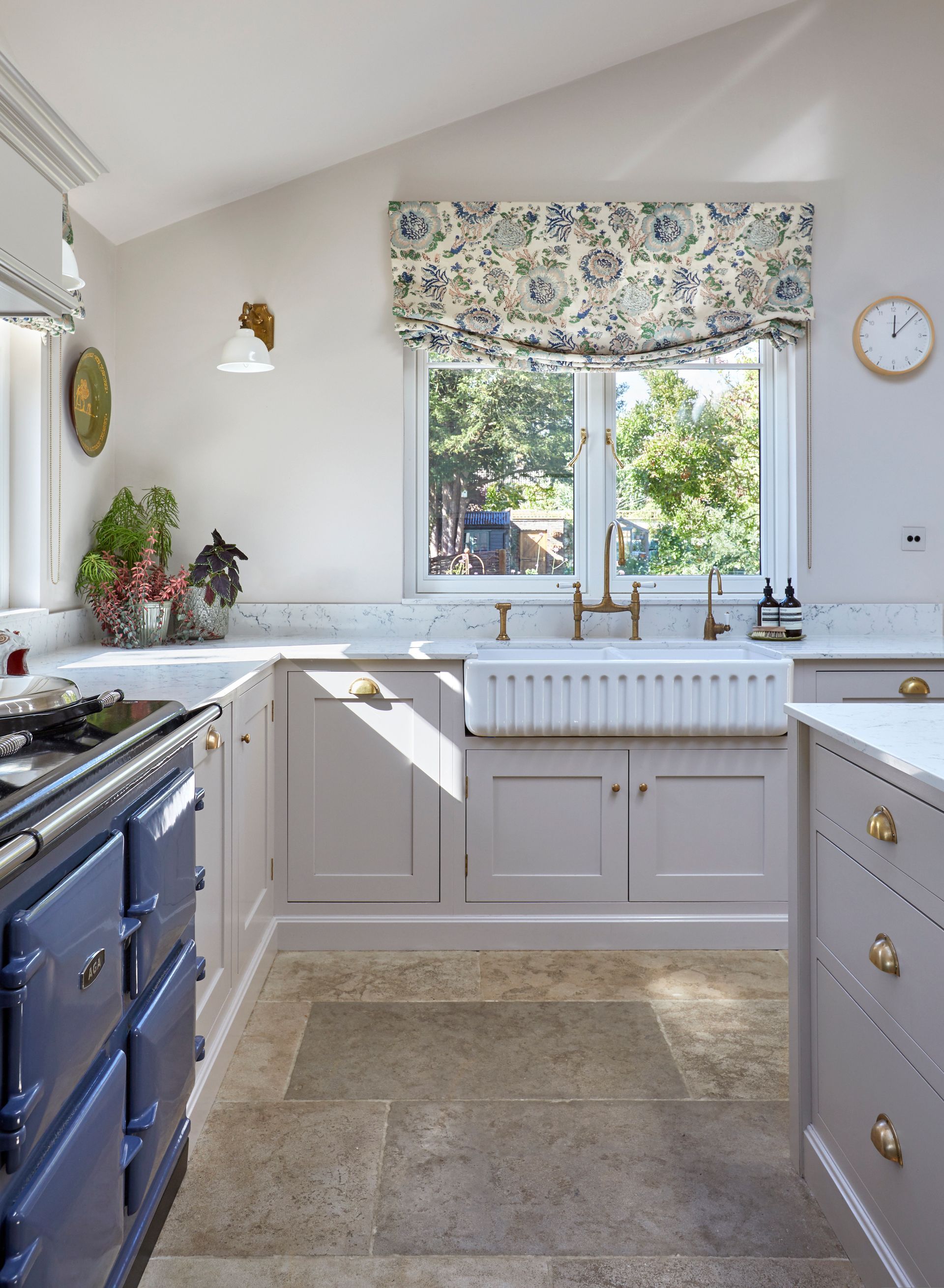 a kitchen with a blue stove and a clock on the wall a kitchen with a blue stove and a clock on the wall