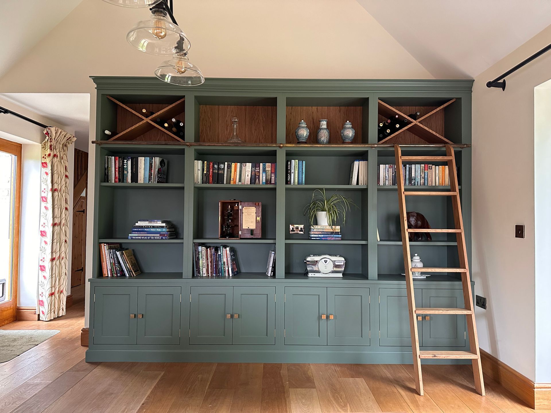 there is a ladder in the middle of bespoke home library .