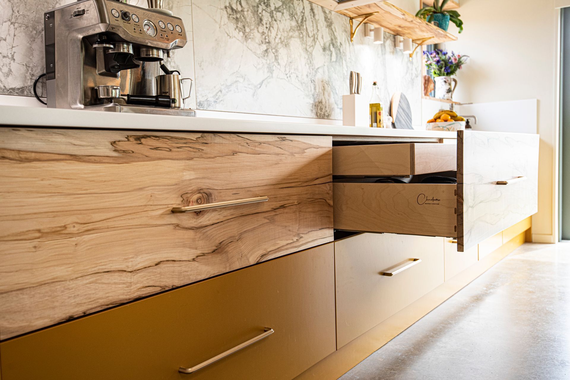 a high end kitchen with wooden drawers and a coffee maker a high end kitchen with wooden drawers and a coffee maker