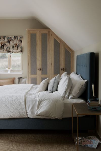 a bedroom with a slanted ceiling and a bed