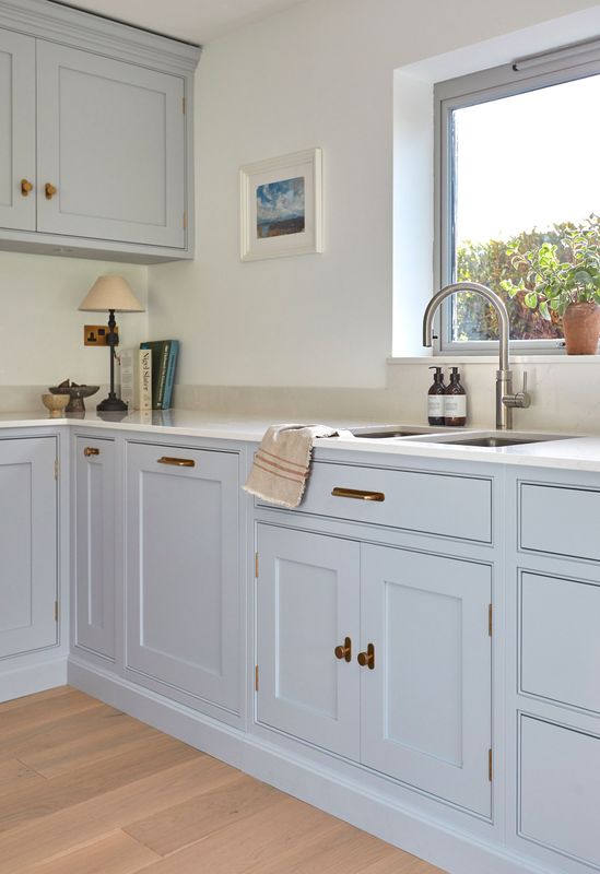 Bespoke kitchen with a sink and a picture on the wall above it