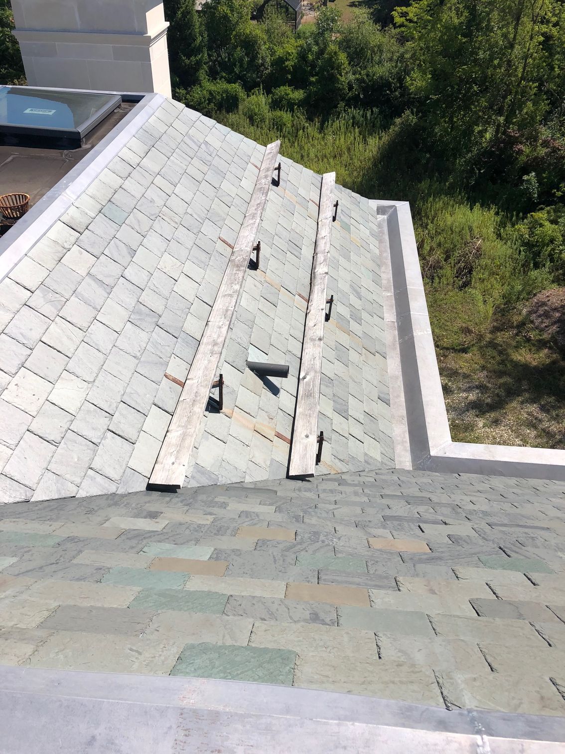 A roof with a lot of shingles on it is being repaired.