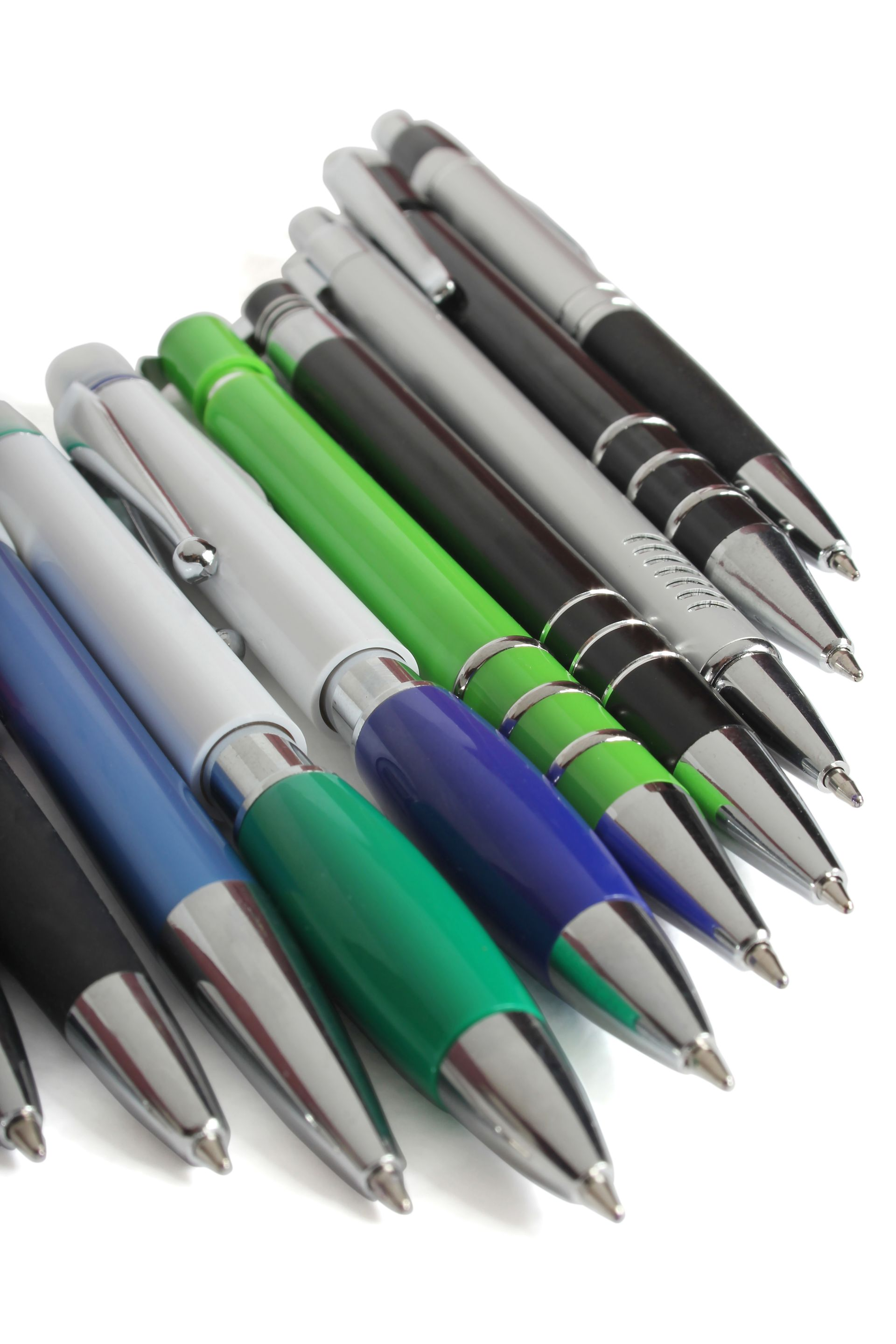 Assortment of pens in various colors: black, blue, green, and silver, arranged diagonally on white.