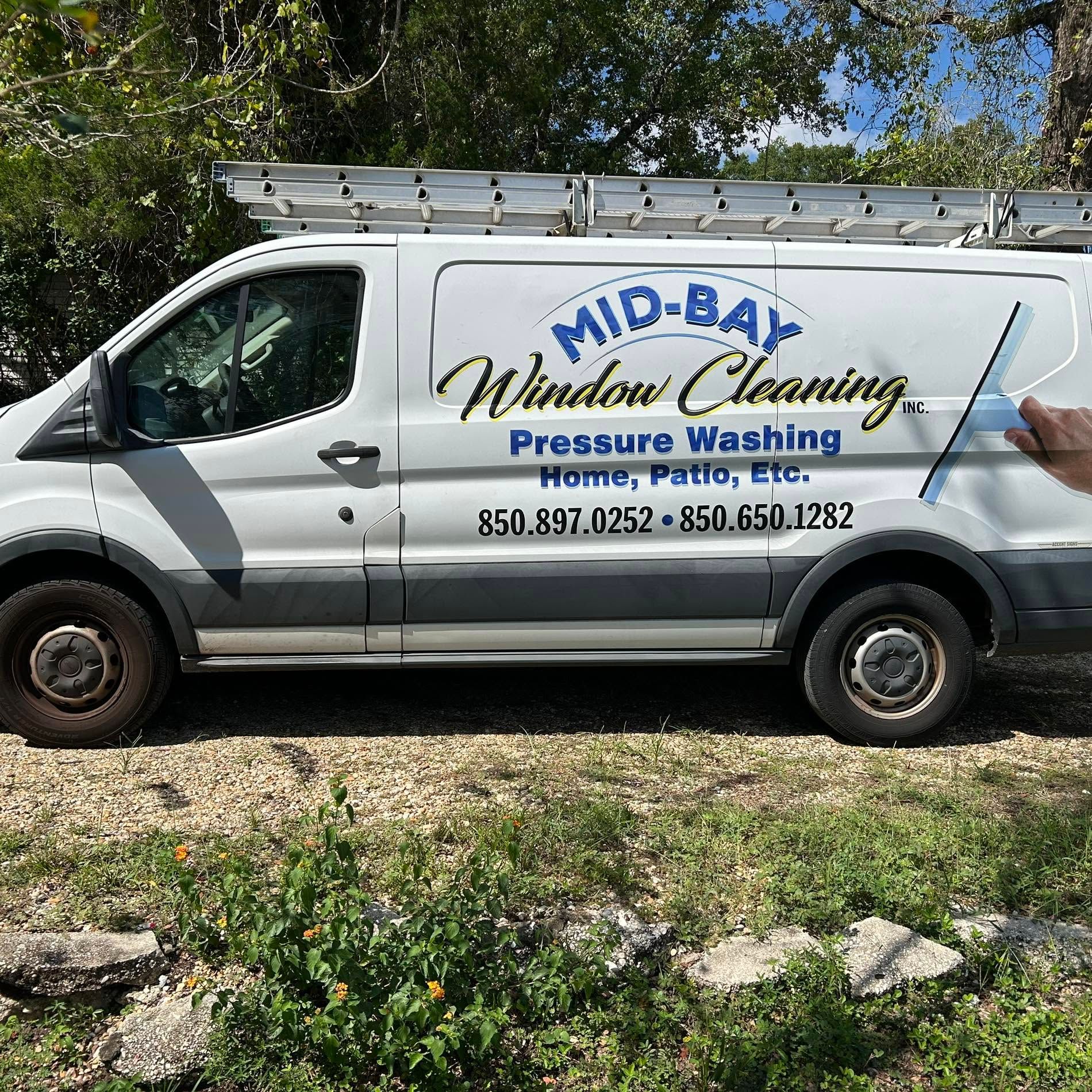 White service van with ladder, labeled “Mid-Bay Window Cleaning” and “Pressure Washing,” parked outdoors.
