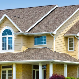 Yellow suburban house with brown shingled roof and white-trimmed windows