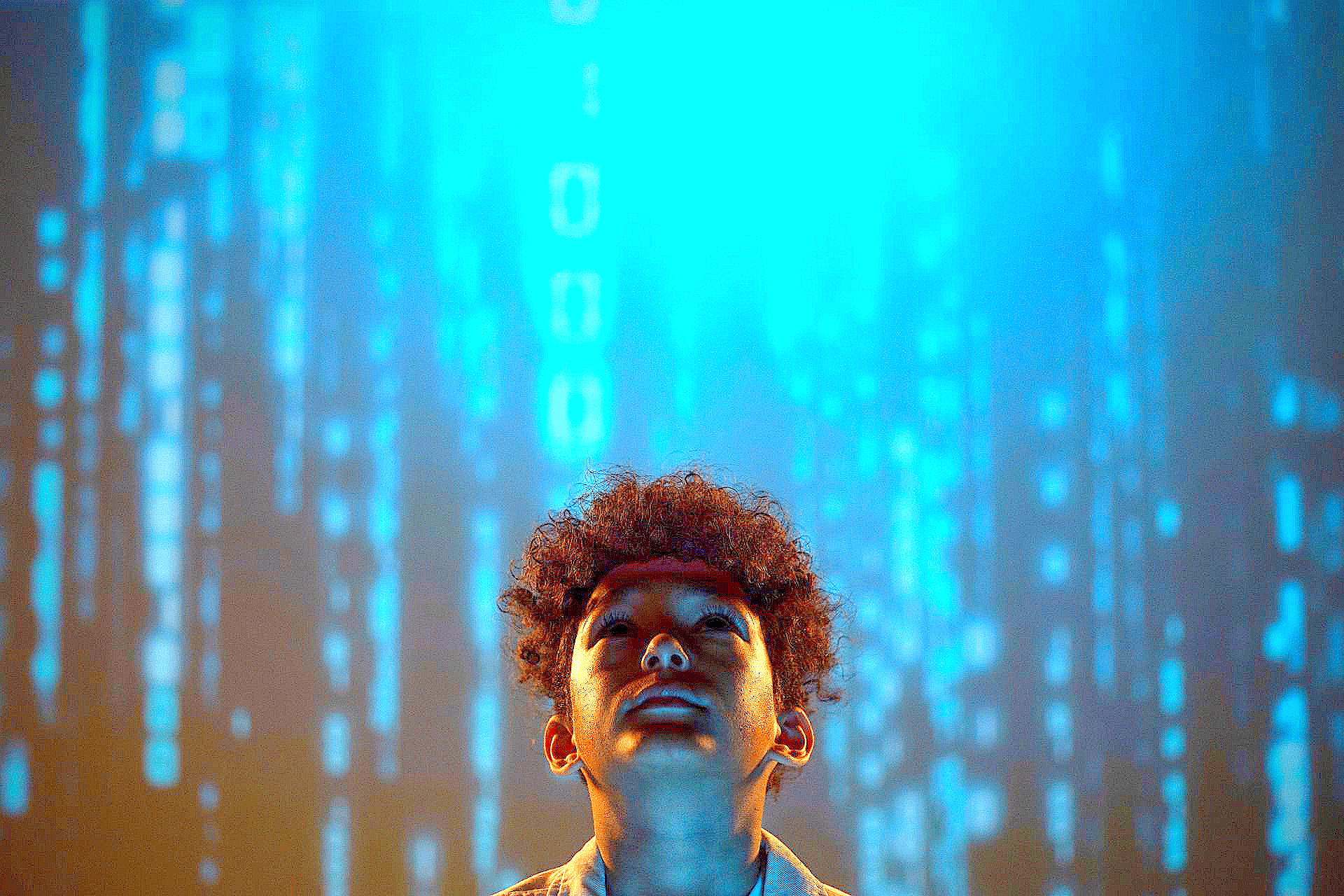 Person looking up amid glowing blue digital code streaks and orange light