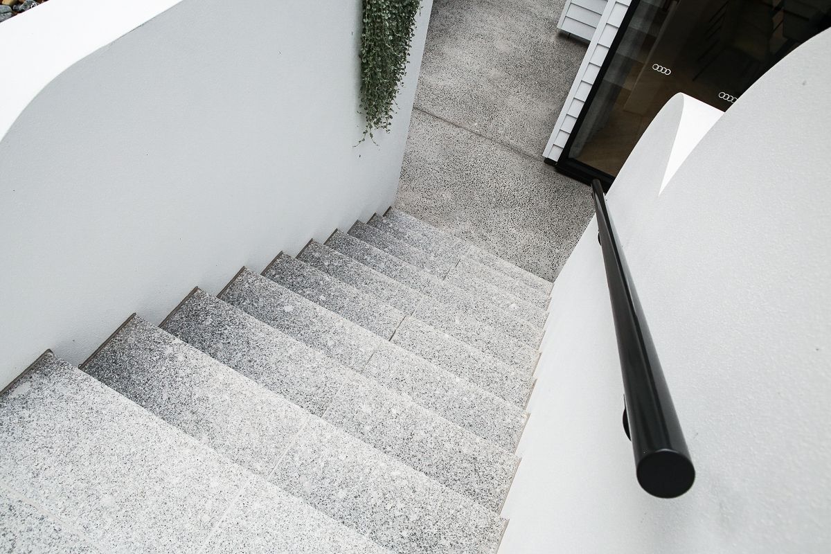 Tiled outdoor staircase with clean edges and rendered wall – Ascot project