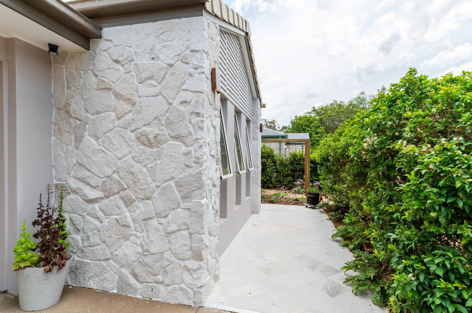 Exterior stone cladding with tiled pathway – Samford residence